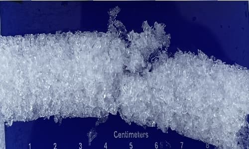 Real snow core cross-section on a centimeter-ruled crystal card